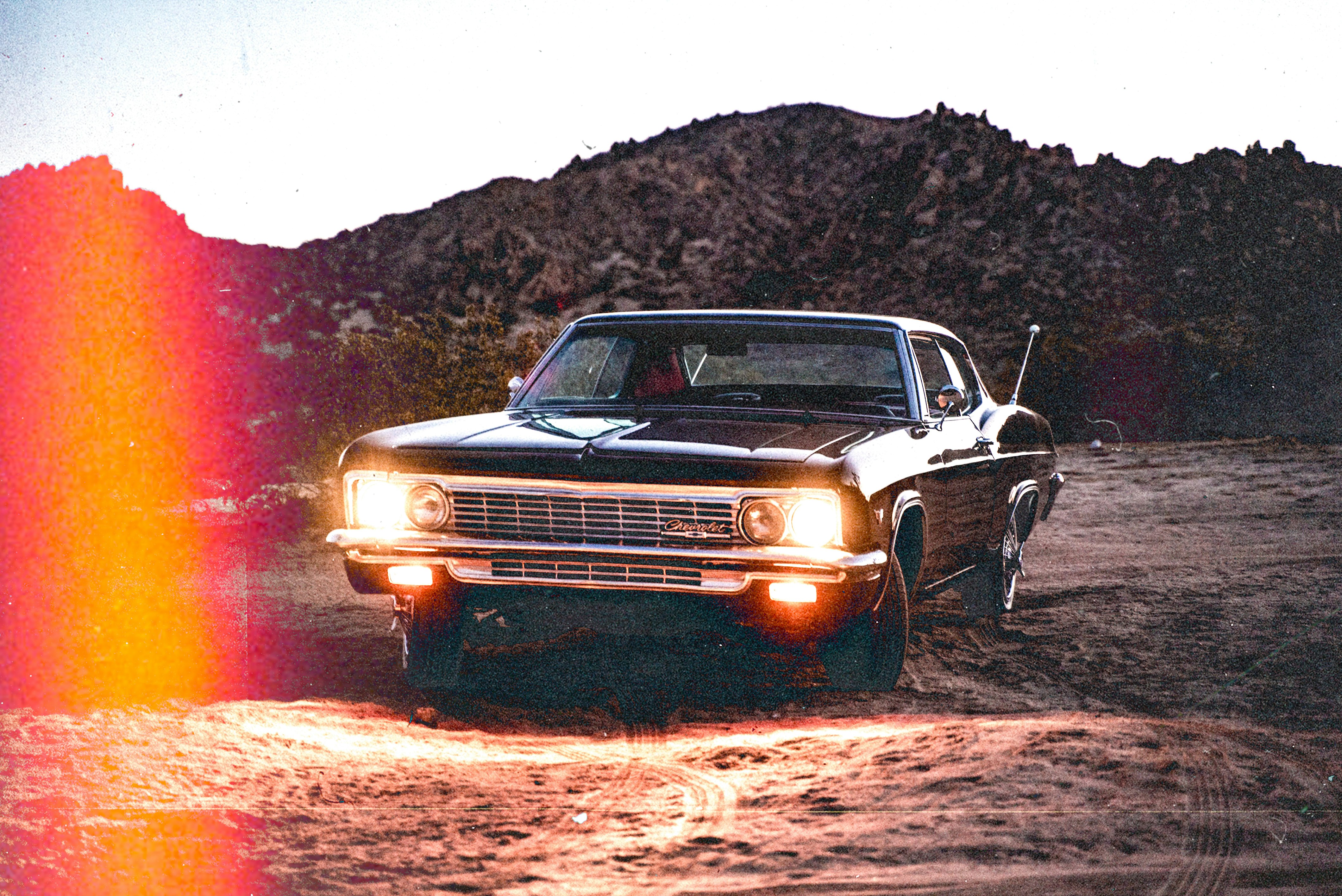 black chevrolet camaro on brown soil